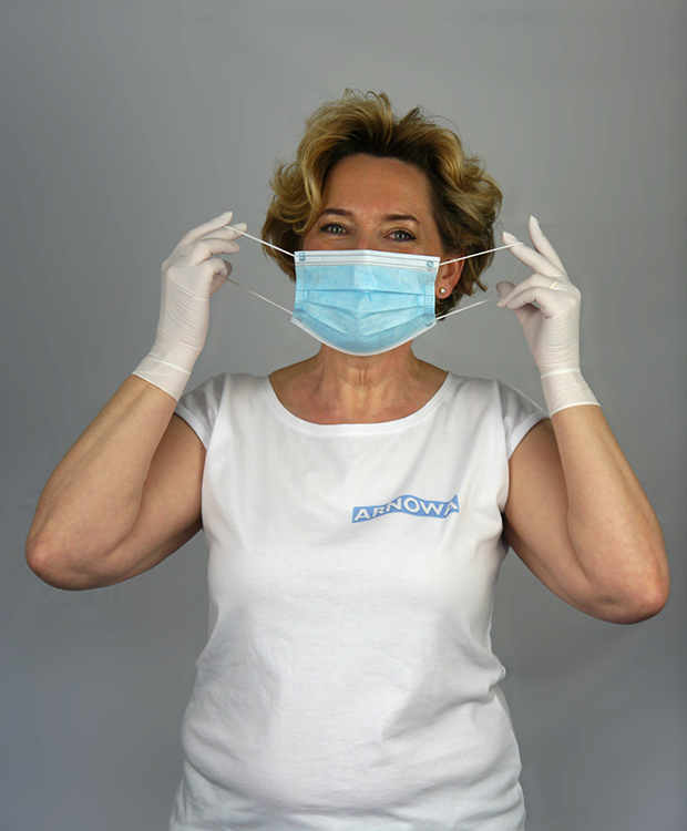mundschutz-moodshot Frau setzt Mundschutz auf